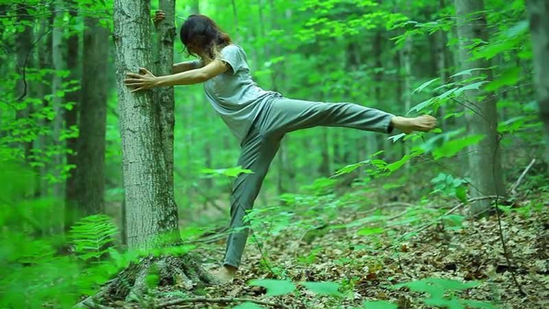 Shinrin-Yoku_exercising_against_a tree_woman_in_forest
